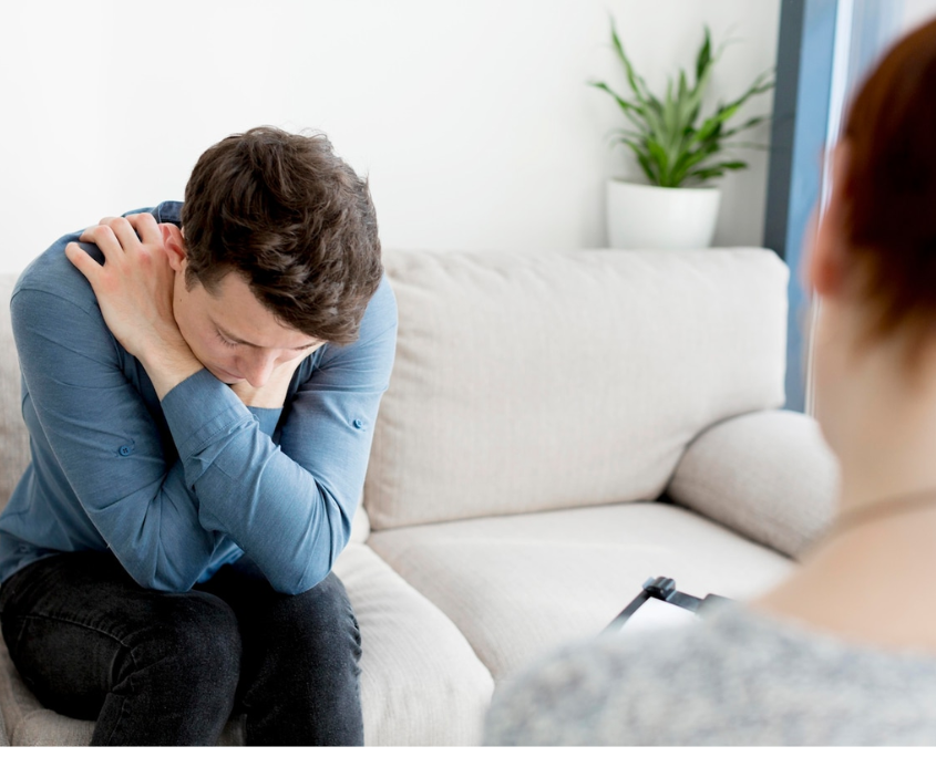 A gay person attending a one-on-one substance abuse therapy session for Adderall addiction