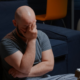 An image of a distressed gay man, showing a symptom of PTSD.