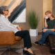A young trangender woman in an emotional therapy session with a counselor, representing the supportive environment of an intensive outpatient treatment program.