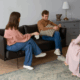 A gay person and two therapists in a trauma therapy session.