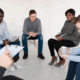 LGBTQ individuals in a support group circle during addiction treatment and recovery session.