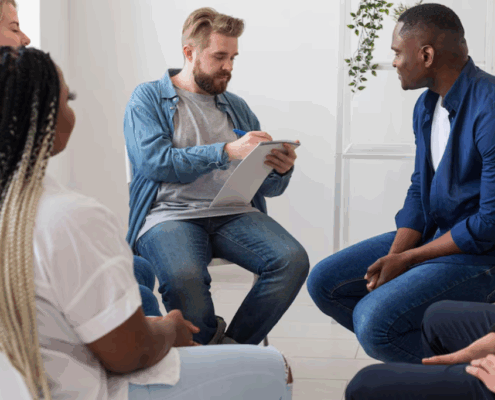 A group therapy among LGBTQ persons and a male therapist.