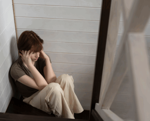 A young lesbian having a panic attacks while on the floor.