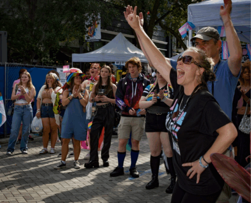 An image of LGBTQ individuals attending pride on the block.