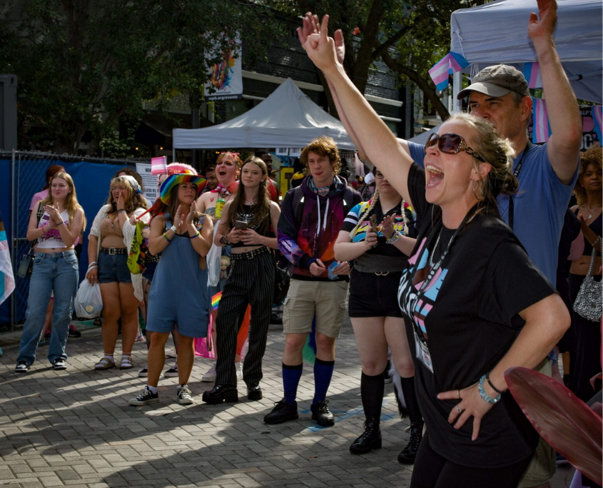 An image of LGBTQ individuals attending pride on the block.