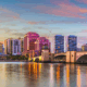 An image buildings and bridge in palm beach gardens across the water.